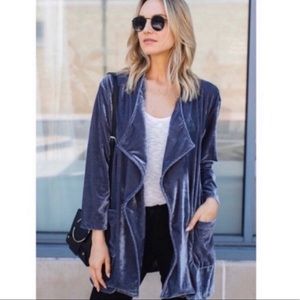 Amaryllis draped in velvet blue cardigan